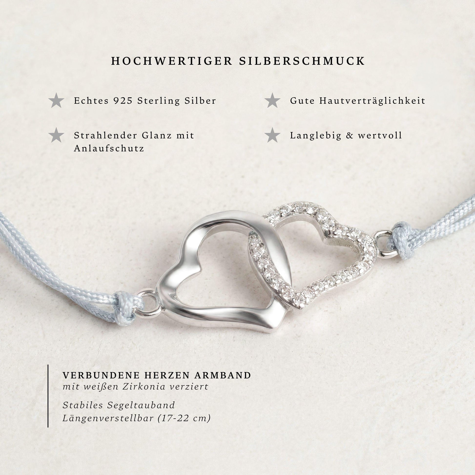 Segeltau-Armband mit zwei verschlungenen Herzen aus 925 Silber und Zirkonia, Nahaufnahme mit Produktinfo: längenverstellbar 17-22 cm